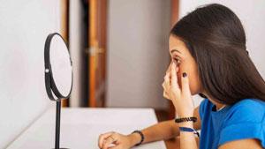 Woman putting in a contact lens